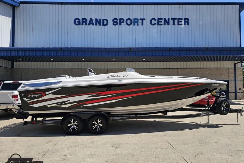 The Image of 2019 Baja 27 Outlaw boat on trailer at Grand Sport Center. - 1