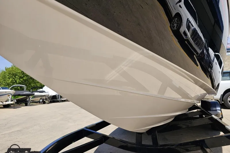 Slide: The Image of 2019 Baja 27 Outlaw boat on trailer, showcasing sleek hull design and reflective surface. - 14