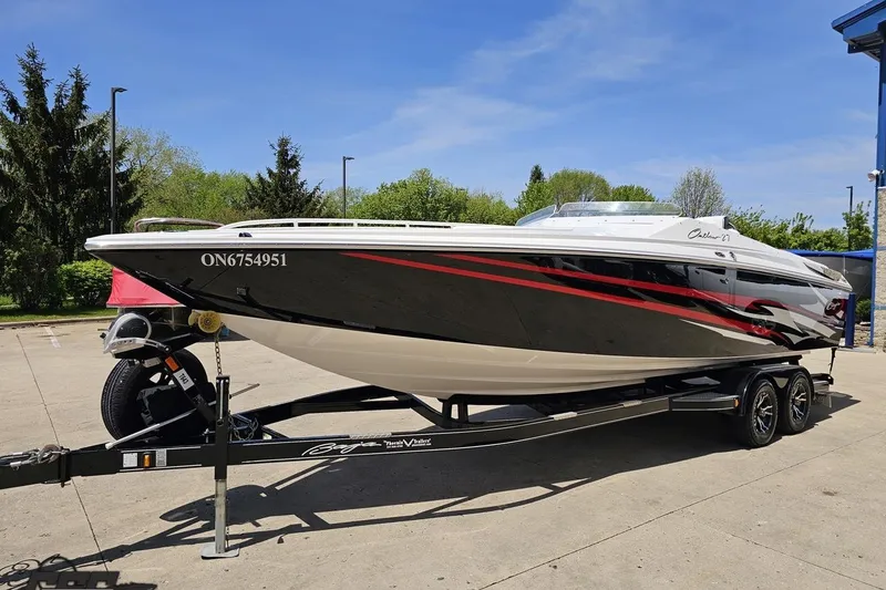 Slide: The Image of 2019 Baja 27 Outlaw speedboat on trailer, parked outdoors on a sunny day. - 15