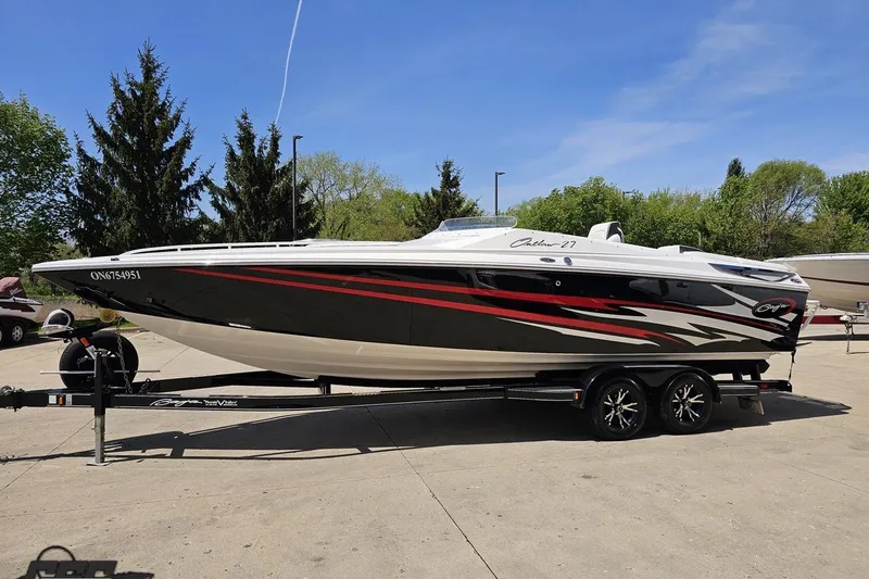 Slide: The Image of 2019 Baja 27 Outlaw boat on trailer, sleek design with red and black accents. - 17