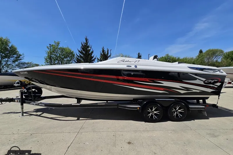 Slide: The Image of 2019 Baja 27 Outlaw speedboat on trailer, featuring sleek black and red design. - 18