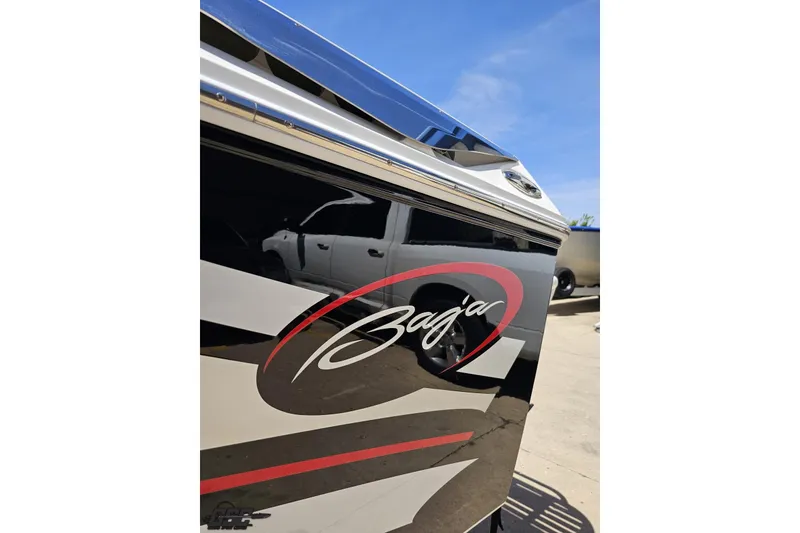 Slide: The Image of 2019 Baja 27 Outlaw boat with sleek black and red design. - 25