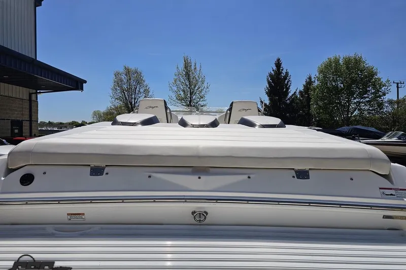 Slide: The Image of 2019 Baja 27 Outlaw boat rear view, showcasing sleek design under clear blue sky. - 27