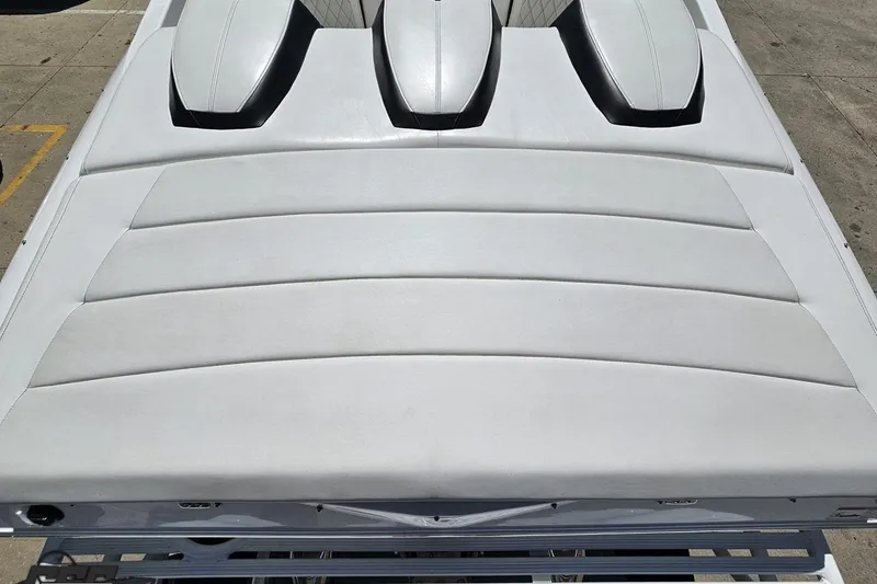 Slide: The Image of 2019 Baja 27 Outlaw boat with sleek white upholstery and aerodynamic design. - 33