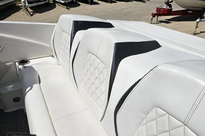 Slide: The Image of 2019 Baja 27 Outlaw boat interior with white leather seats and diamond stitching. - 36