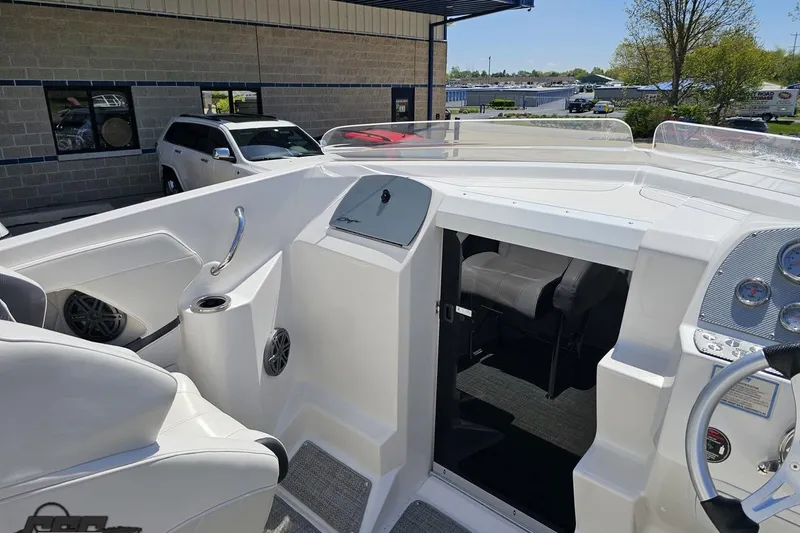 Slide: The Image of 2019 Baja 27 Outlaw boat interior with steering wheel and seating area. - 41