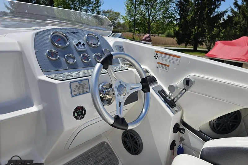 Slide: The Image of 2019 Baja 27 Outlaw boat dashboard with steering wheel and control panel. - 44