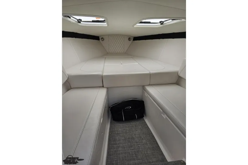 Slide: The Image of Interior cabin of 2019 Baja 27 Outlaw boat with cushioned seating. - 49