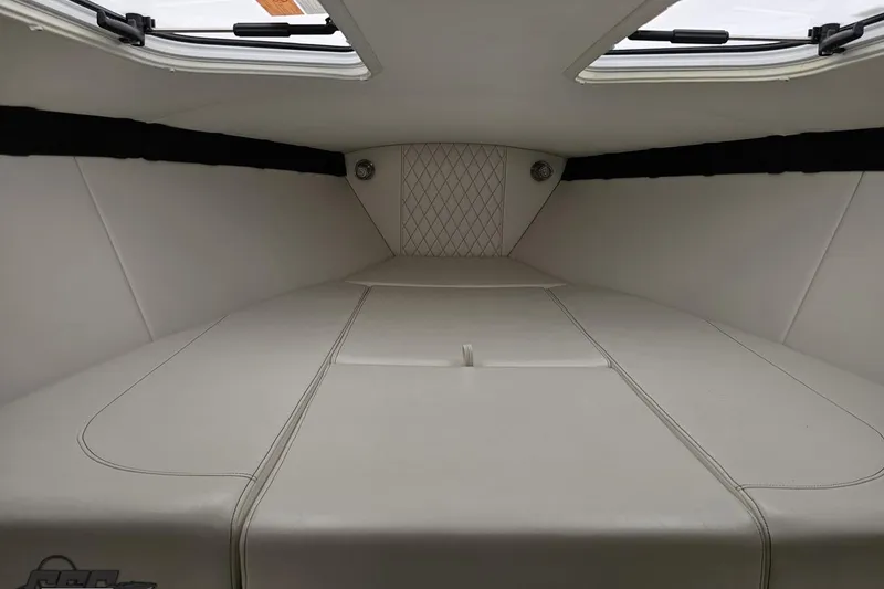 Slide: The Image of Interior cabin of 2019 Baja 27 Outlaw boat with white upholstery. - 51