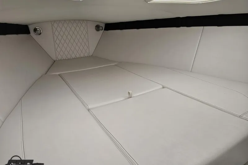 Slide: The Image of Interior cabin of 2019 Baja 27 Outlaw boat with white upholstery. - 53