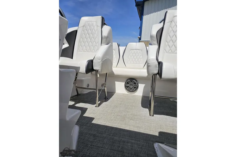 Slide: The Image of 2019 Baja 27 Outlaw boat interior with white leather seating and speaker detail. - 58