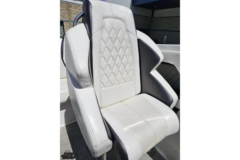Slide: The Image of 2019 Baja 27 Outlaw boat seat with white and gray upholstery, featuring diamond stitching. - 60