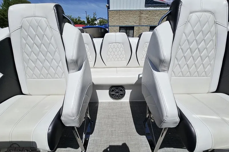 Slide: The Image of 2019 Baja 27 Outlaw boat interior with white diamond-stitched seats and speaker. - 61