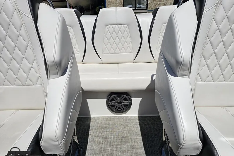 Slide: The Image of 2019 Baja 27 Outlaw boat interior with white leather seats and speaker. - 62