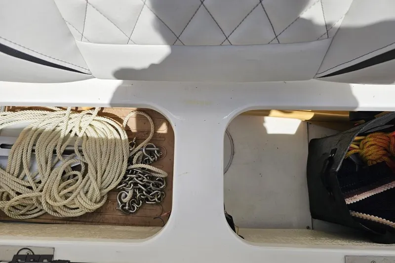 Slide: The Image of Storage compartments on a 2019 Baja 27 Outlaw boat with ropes and chains. - 64