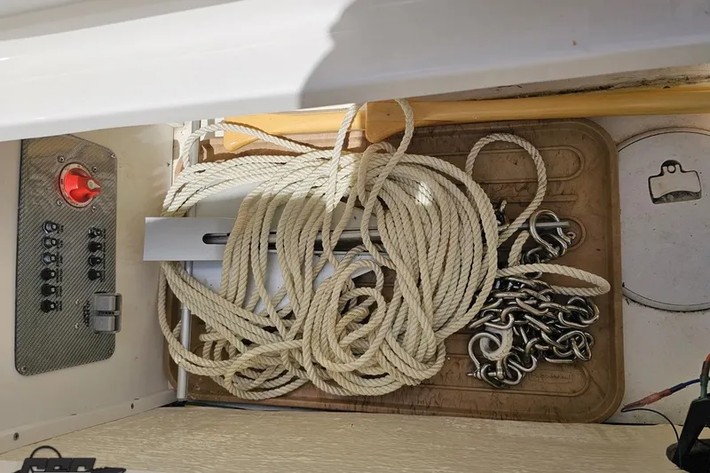 Slide: The Image of Storage compartment of a 2019 Baja 27 Outlaw boat with ropes and chains. - 65