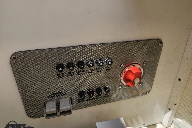Slide: The Image of Control panel of a 2019 Baja 27 Outlaw boat with switches and a red dial. - 66