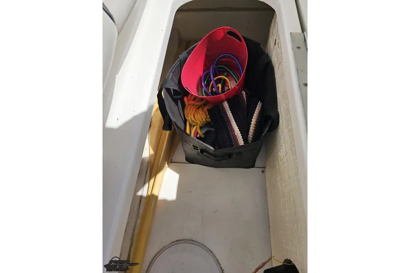 Slide: The Image of Storage compartment of a 2019 Baja 27 Outlaw boat with ropes and accessories. - 67
