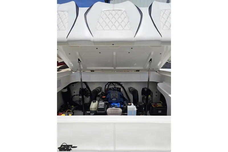 Slide: The Image of Engine compartment of a 2019 Baja 27 Outlaw boat with open hatch. - 68