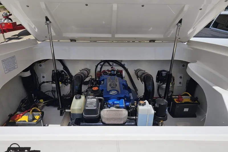 Slide: The Image of Engine compartment of a 2019 Baja 27 Outlaw boat, showcasing detailed components. - 69