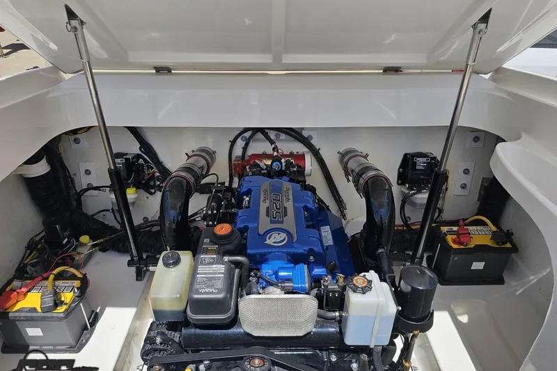 Slide: The Image of Engine compartment of a 2019 Baja 27 Outlaw boat, featuring a powerful 520 engine. - 70