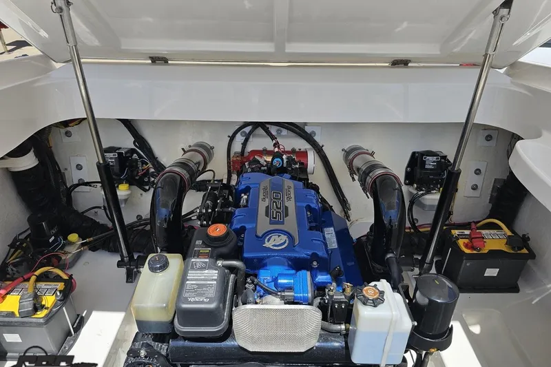 Slide: The Image of Engine compartment of a 2019 Baja 27 Outlaw boat, showcasing a powerful engine setup. - 71