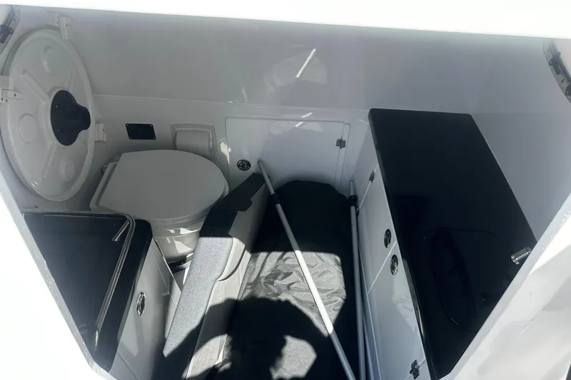 Slide: The Image of Interior cabin of 2026 Monterey Elite 30 OB boat, featuring seating and storage. - 15