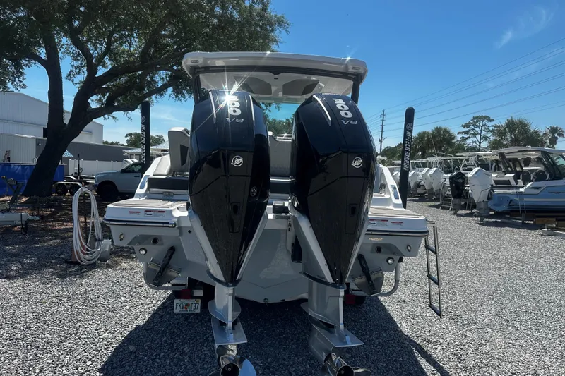 Slide: The Image of 2026 Monterey Elite 30 OB boat with dual 300 V8 engines, parked outdoors. - 3