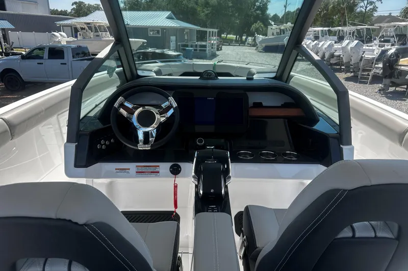 Slide: The Image of Cockpit of 2026 Monterey Elite 30 OB boat with modern steering and controls. - 6