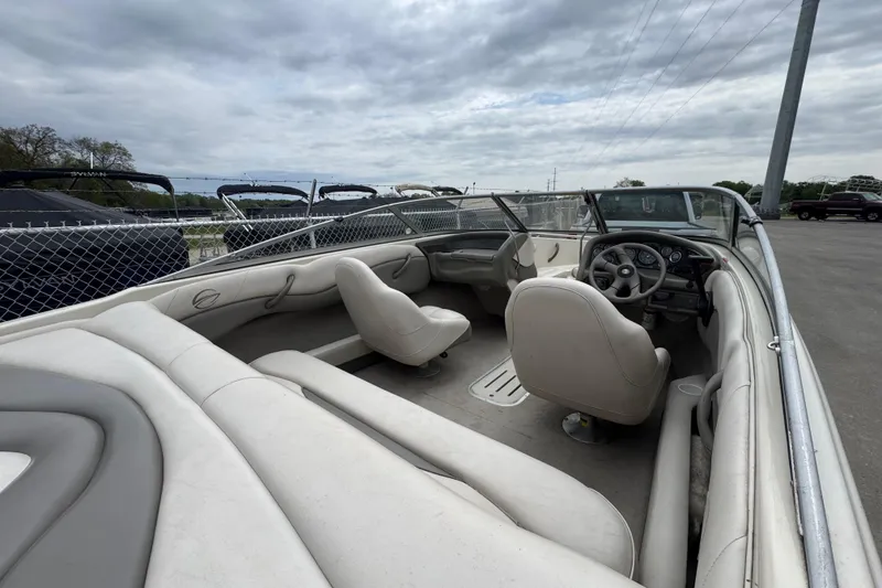 Slide: The Image of Interior view of a 2000 Crownline 180 BR boat with seating and steering wheel. - 3