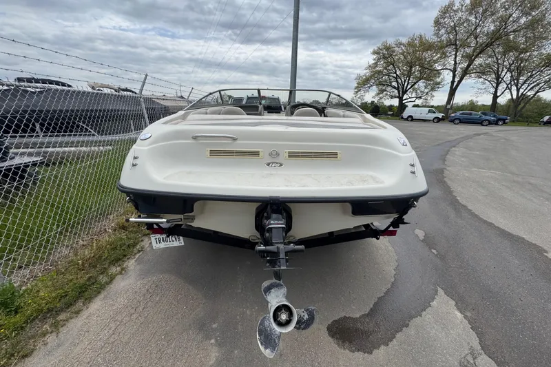Slide: The Image of Rear view of a 2000 Crownline 180 BR boat parked on a paved lot. - 4