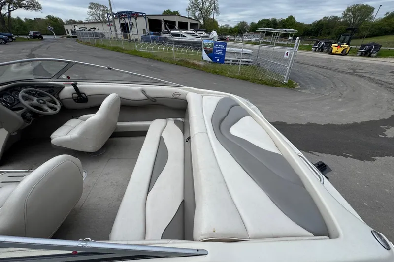 Slide: The Image of Interior of a 2000 Crownline 180 BR boat with white and gray seating. - 6