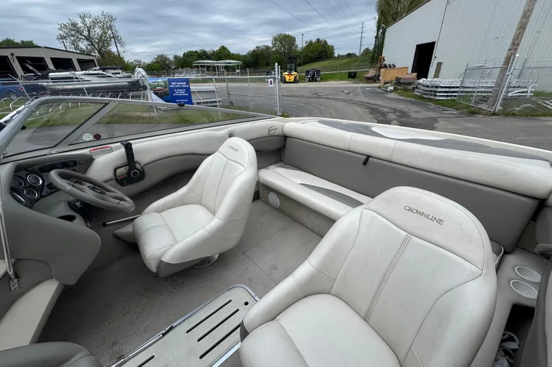 Slide: The Image of Interior of a 2000 Crownline 180 BR boat with white seating and steering wheel. - 7