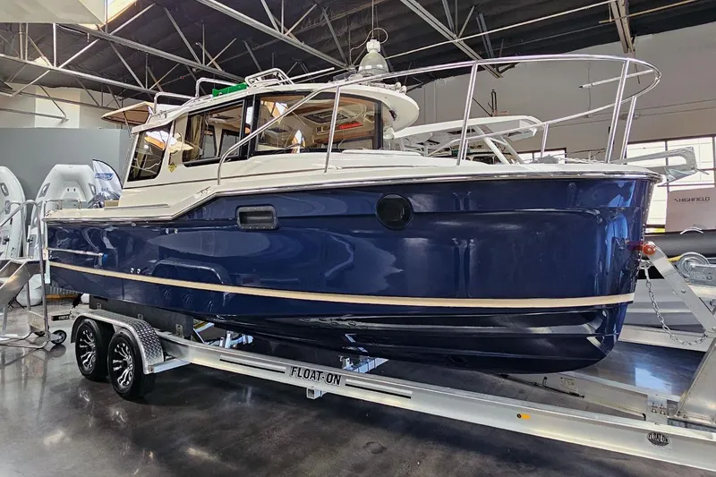 Slide: The Image of 2025 Ranger Tug R23 Luxury Edition boat on trailer in showroom. - 15