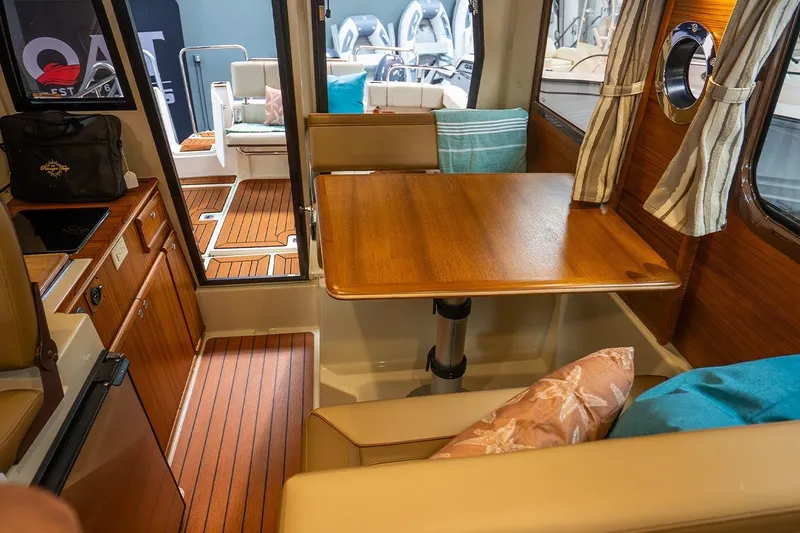 Slide: The Image of 2025 Ranger Tug R23 Luxury Edition interior with wooden table and seating area. - 4