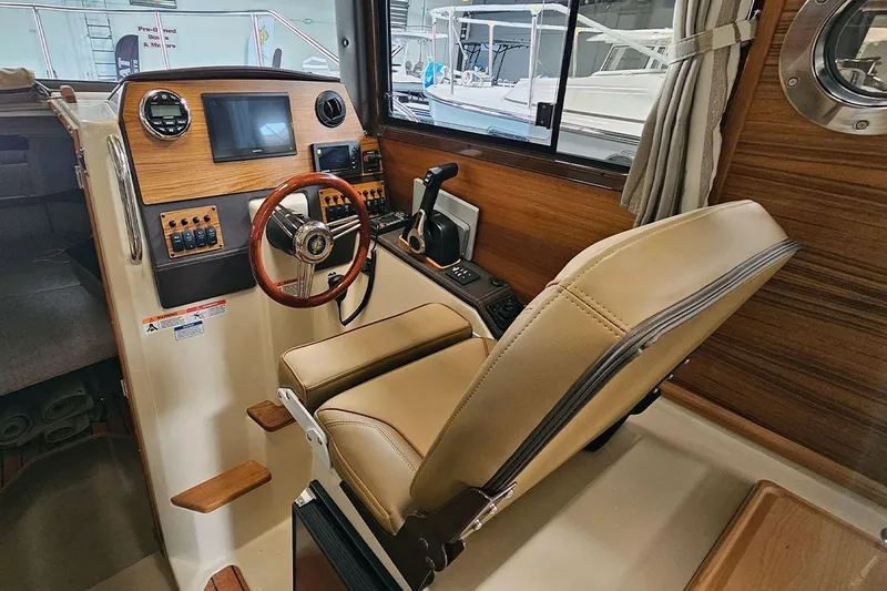 Slide: The Image of Interior of 2025 Ranger Tug R23 Luxury Edition with modern helm and leather seating. - 6