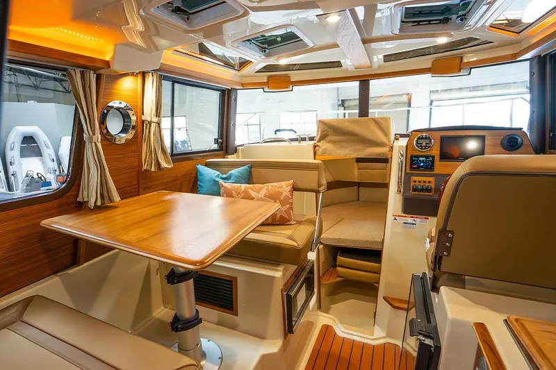 Slide: The Image of Interior of 2025 Ranger Tug R23 Luxury Edition with elegant seating and wooden table. - 7