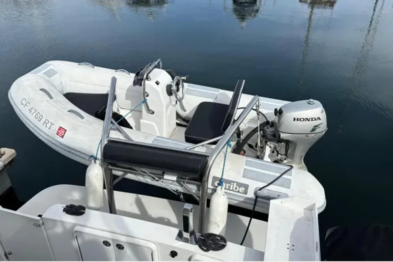 Slide: The Image of Inflatable boat with Honda motor docked beside Carver 41 Cockpit Motor Yacht, 2005 model. - 4