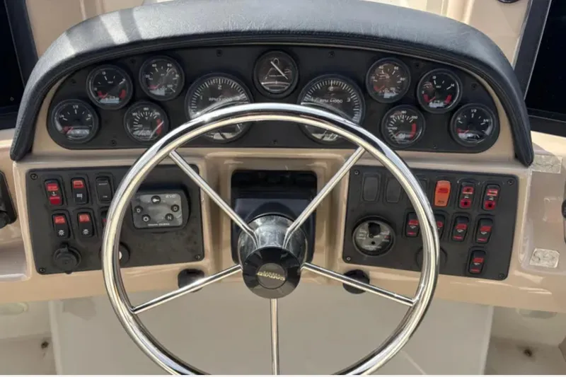 Slide: The Image of Control panel of a 2005 Carver 41 Cockpit Motor Yacht with steering wheel and gauges. - 6