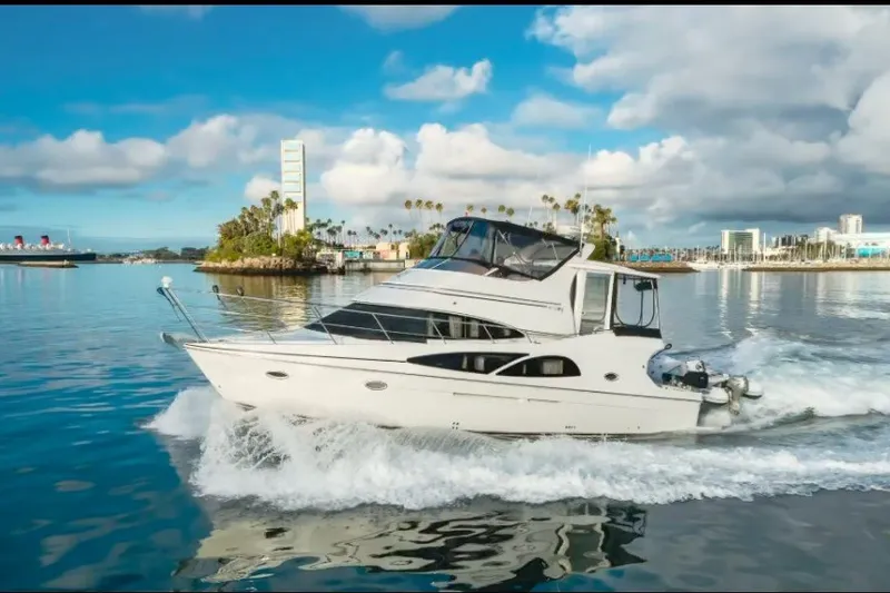 The Image of 2005 Carver 41 Cockpit Motor Yacht cruising on a sunny day with scenic backdrop. - 0