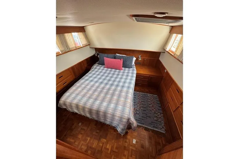 Slide: The Image of Cozy bedroom in 2000 Grand Banks 36 Classic yacht with wood paneling and large bed. - 11
