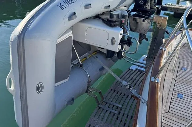 Slide: The Image of Inflatable dinghy attached to a 2000 Grand Banks 36 Classic yacht at a dock. - 17