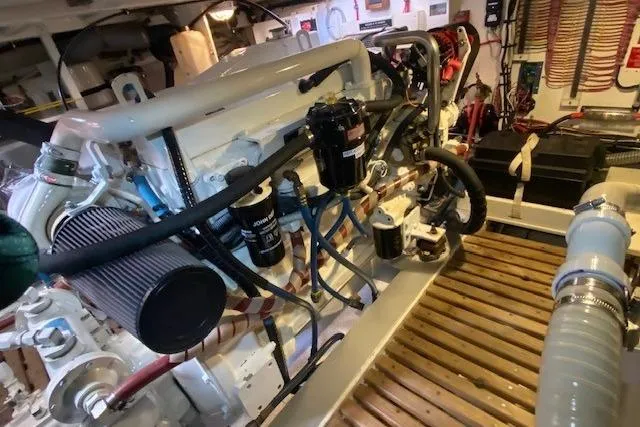 Slide: The Image of Engine room of a 2000 Grand Banks 36 Classic yacht, showcasing detailed machinery and components. - 19