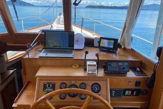Slide: The Image of Helm of 2000 Grand Banks 36 Classic yacht with navigation equipment and scenic ocean view. - 2