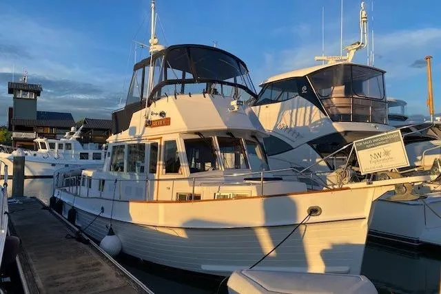 Slide: The Image of 2000 Grand Banks 36 Classic yacht docked at marina during sunset. - 22