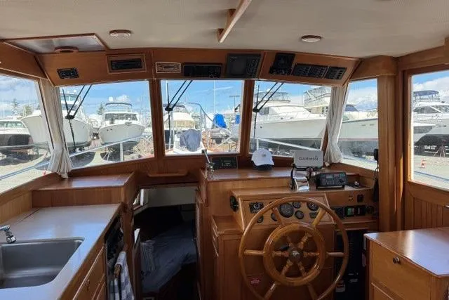 Slide: The Image of Interior view of 2000 Grand Banks 36 Classic yacht with wooden helm and navigation equipment. - 3
