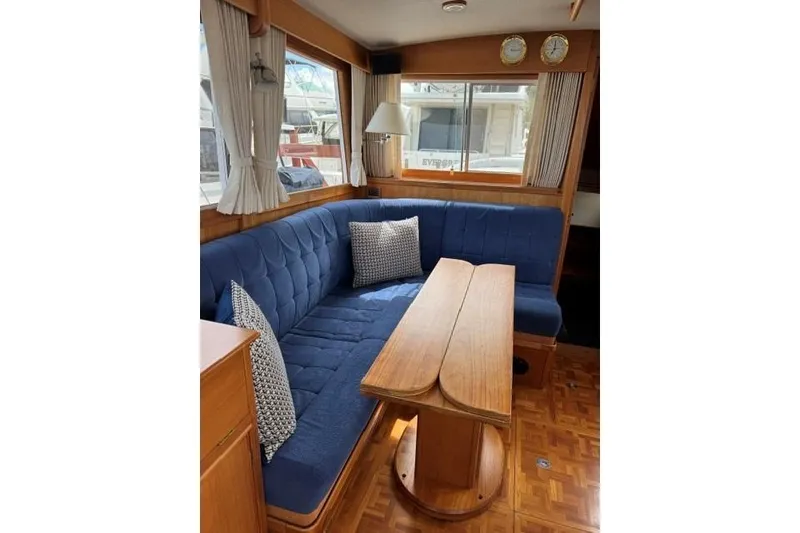 Slide: The Image of Interior of 2000 Grand Banks 36 Classic yacht with blue seating and wooden table. - 9