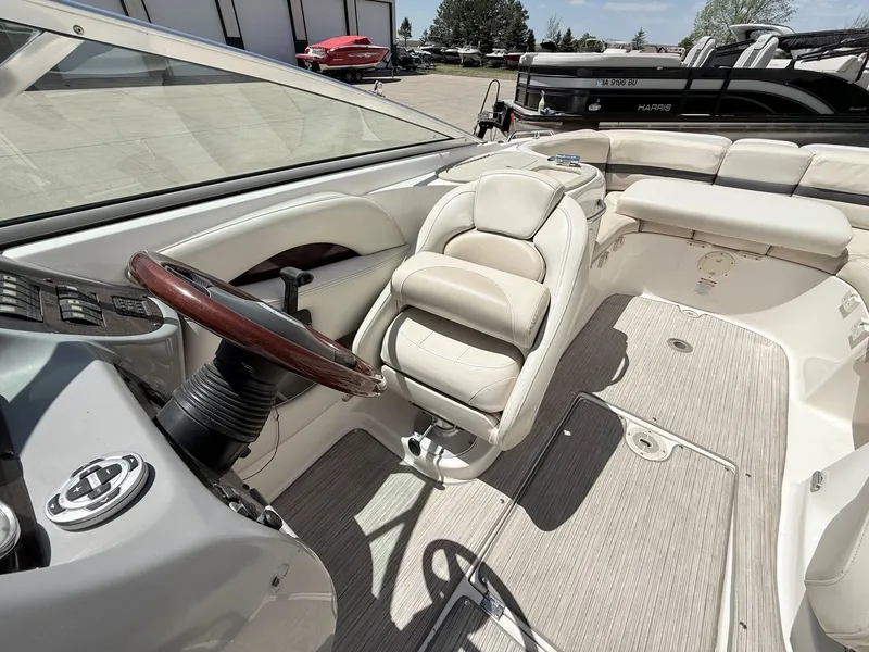 Slide: The Image of Interior of a 2004 Chaparral 256 SSi boat with steering wheel and seat. - 19