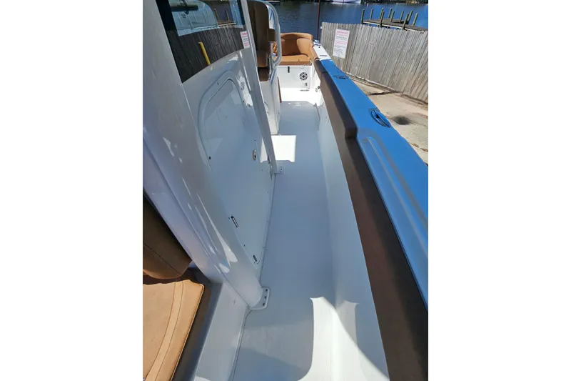 Slide: The Image of 2026 Sea Hunt Ultra 255 SE boat interior with sleek white deck and comfortable seating. - 26