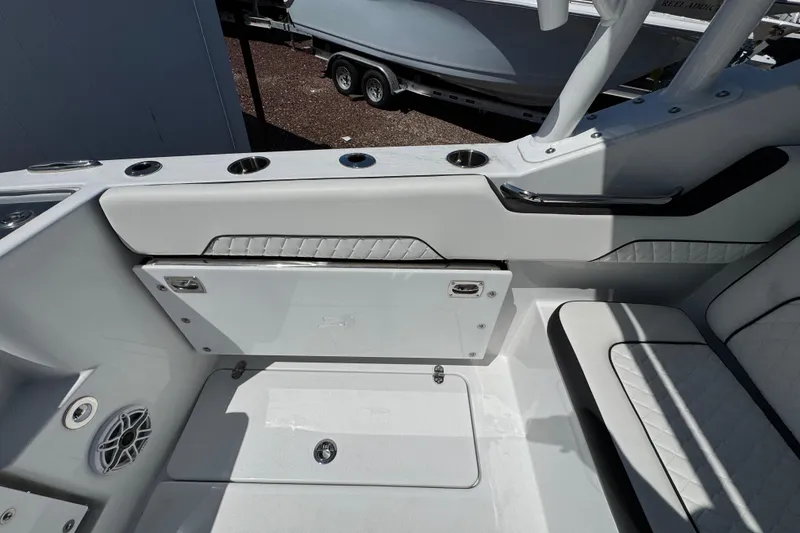 Slide: The Image of Interior of 2026 Stingray 259 DC boat, featuring sleek seating and cup holders. - 10
